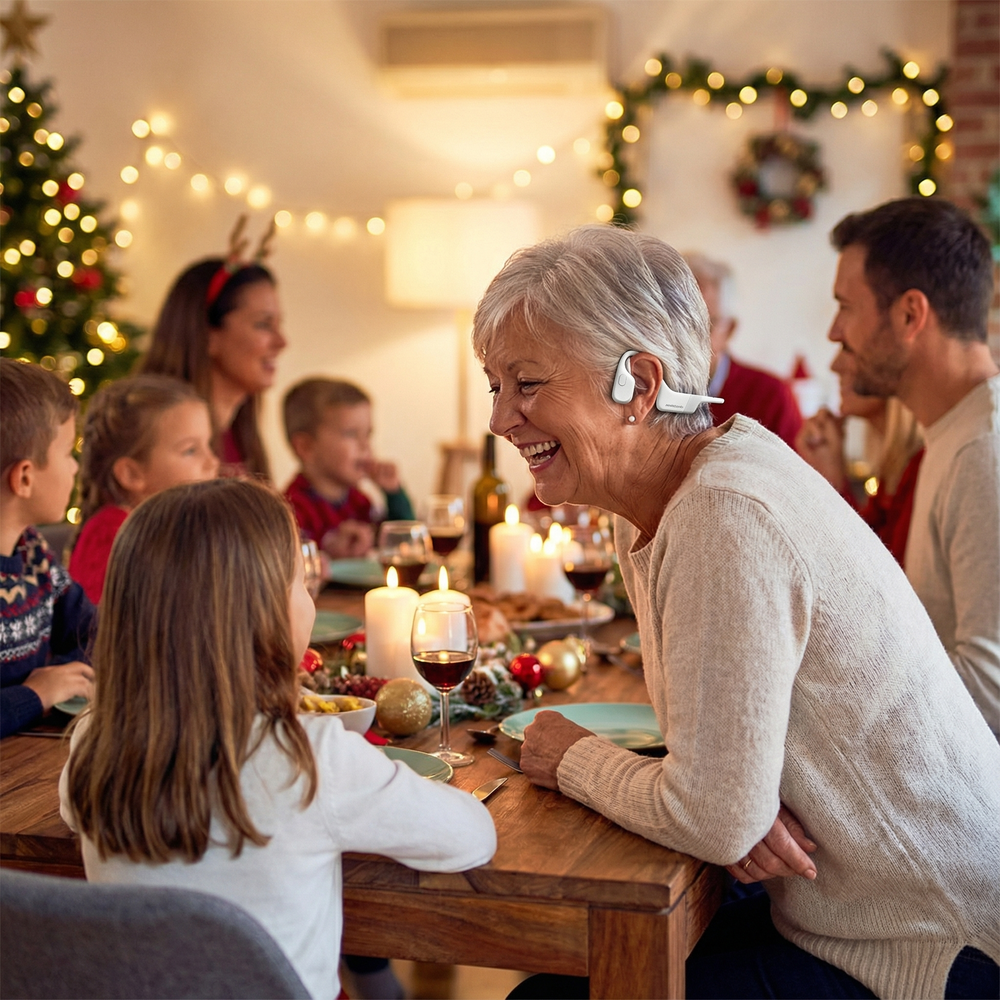 Grandmother wearing hearing assist earphones enjoying Christmas dinner with family